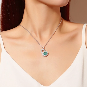 Elegant S925 sterling silver necklace with green gemstone gourd pendant worn by model