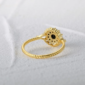 Macro detail of S925 hallmark on gold plated twisted rope ring with black stone