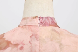 Close-up of pink mesh dress featuring a high collar and invisible back zipper detail