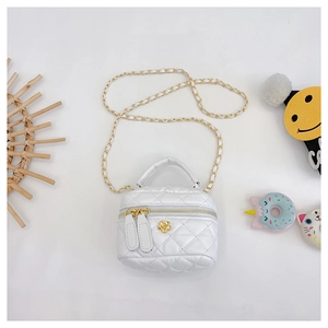 Detail of white quilted crossbody bag with golden chain and camellia flower ornament