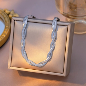 Elegant 18K gold double layered snake chain necklace on luxury champagne jewelry box