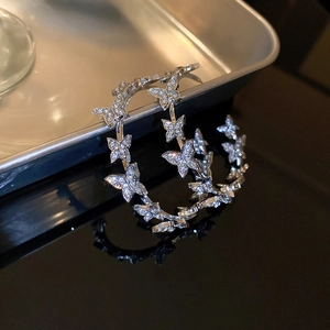 Detailed view of silver butterfly hoop earrings with sparkling crystal rhinestones