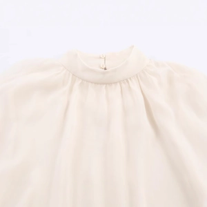 Elegant cream georgette top featuring a pleated high neck and pearl button closures