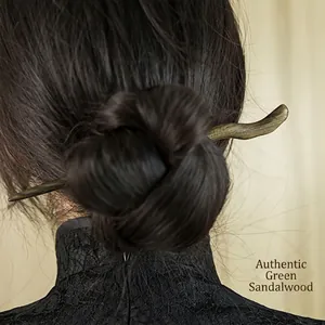 Handmade green sandalwood hair pin with wavy design shown on a classic updo hairstyle