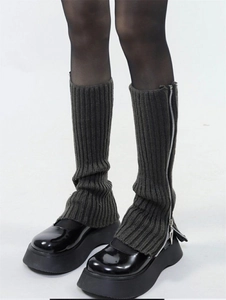 Detail of dark grey knit leg warmers with side zipper design and platform shoes