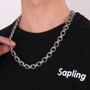 Detailed close-up of vintage silver chain links with intricate S-shaped engraved patterns