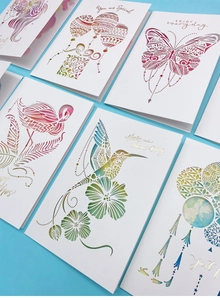 Detail of 3D pop-up greeting cards featuring intricate laser-cut butterfly and floral patterns