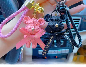 Detail of pink and black resin bears with woven texture and Love Is Eternal ribbons