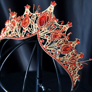 Macro detail of luxury bridal crown featuring red rhinestones and gold alloy base