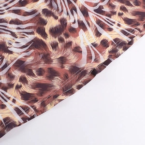 Detailed close-up showing the precise double-stitched hem on the animal print dress fabric