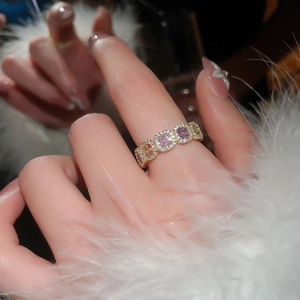 Detailed view of 14k gold plated ring with colorful zircon stones on model finger