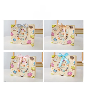 Detail of cartoon doughnut gift bags with colorful silk ribbons and cute animal prints