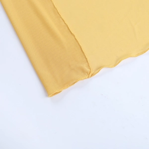 Detail of yellow mesh fabric and knit stitching on asymmetric beach vacation dress
