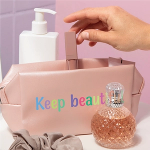 Detailed close-up of pink PU leather makeup bag with colorful Keep beaut embroidery