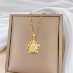 Elegant gold titanium steel necklace featuring a hollow star pendant with cat eye stone