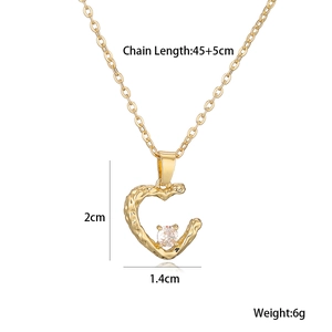 Detailed view of irregular gold heart pendant with cubic zirconia and size measurements