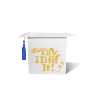 Detail of white paper graduation card box with golden glitter text and blue tassel