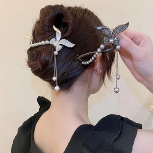 Elegant gold butterfly hair clip with pearls and long tassels on woman hair