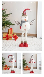 Detail of plush Christmas snowmen with long legs and festive embroidery in cozy holiday setting