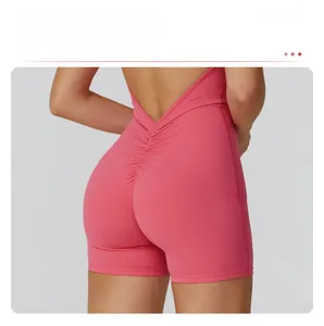 Detail of ruched booty lifting design and crisscross straps on back of pink jumpsuit