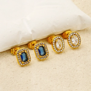 Chic gold titanium steel stud earrings with blue and clear zircon gemstones on white surface