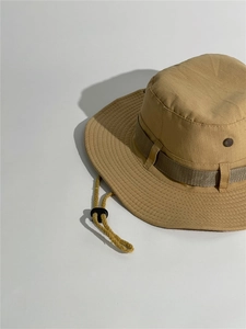 Detail view of khaki outdoor sun hat featuring breathable metal eyelets and adjustable cord
