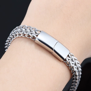 Detailed macro shot of a thick silver wheat chain bracelet with a magnetic clasp