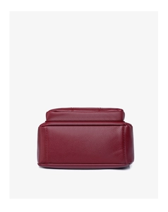 Detail view of burgundy pebble leather shoulder bag base with precise stitching craft
