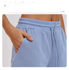 Detail of light blue athletic shorts featuring side pockets and a drawstring waistband