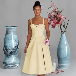 Chic light yellow midi dress featuring delicate spaghetti straps and a side slit detail