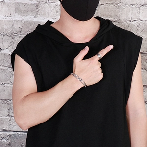 Street style shot of silver stainless steel NK chain bracelet and bold ring for men