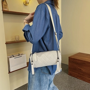 Chic white quilted cylindrical crossbody bag with silver hardware for women