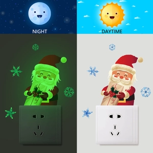 Luminous Santa Claus switch sticker showing day and night glowing effect on the wall
