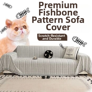 Detail of light gray fishbone pattern sofa throw with fringe and cat-resistant fabric