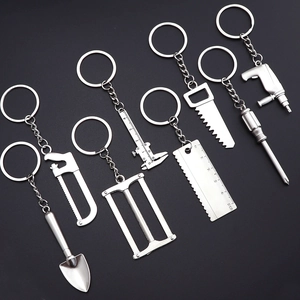 Miniature silver metal hardware tool keychain set featuring wrench and pliers charms