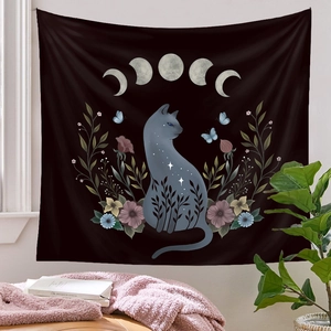 Detail of wall tapestry featuring a gray cat silhouette with moon phases and flowers