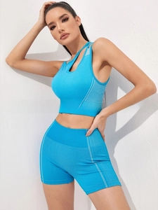 Detail of blue seamless yoga set showing cutout shoulder strap and high waist texture