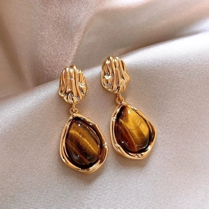 14K gold plated oval tiger eye earrings with vintage style on pink silk fabric
