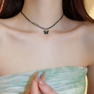 Detail shot of a double-layer beaded butterfly choker necklace on a female neck