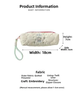 Detail of embroidered white quilted pencil case with rabbit motif and size dimensions