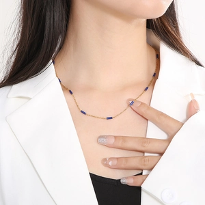 Minimalist 1.5mm titanium steel necklace with dark blue enamel beads on a female model