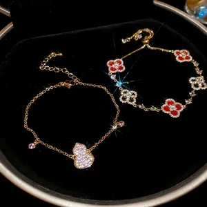 18k gold plated bracelet with zircon gourd and clover charms on black velvet tray