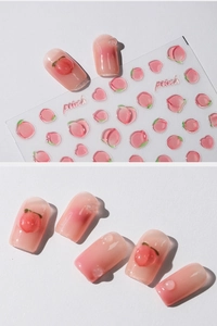 Detailed view of peach-themed nail stickers with 3D resin drops and pink gradient art