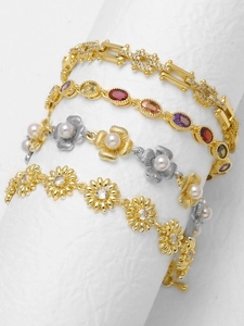 Detailed view of 18k gold plated bracelets with pearls and multi-colored zircon stones