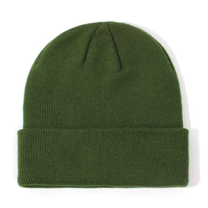 Close-up of a dark green knitted baby beanie showing fine ribbed texture for winter