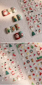 Close-up of 3D embossed Christmas nail stickers with Santa Claus and reindeer designs
