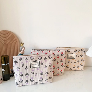 Floral corduroy makeup bags in three colors featuring tulip patterns for travel storage