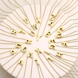 Golden stainless steel A-Z alphabet initial pendant necklaces set on round display