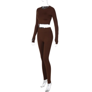 Detail view of high-elastic knit texture and side seams of dark brown yoga set