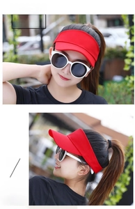 Detail of red athletic sun visor with breathable fabric and adjustable strap